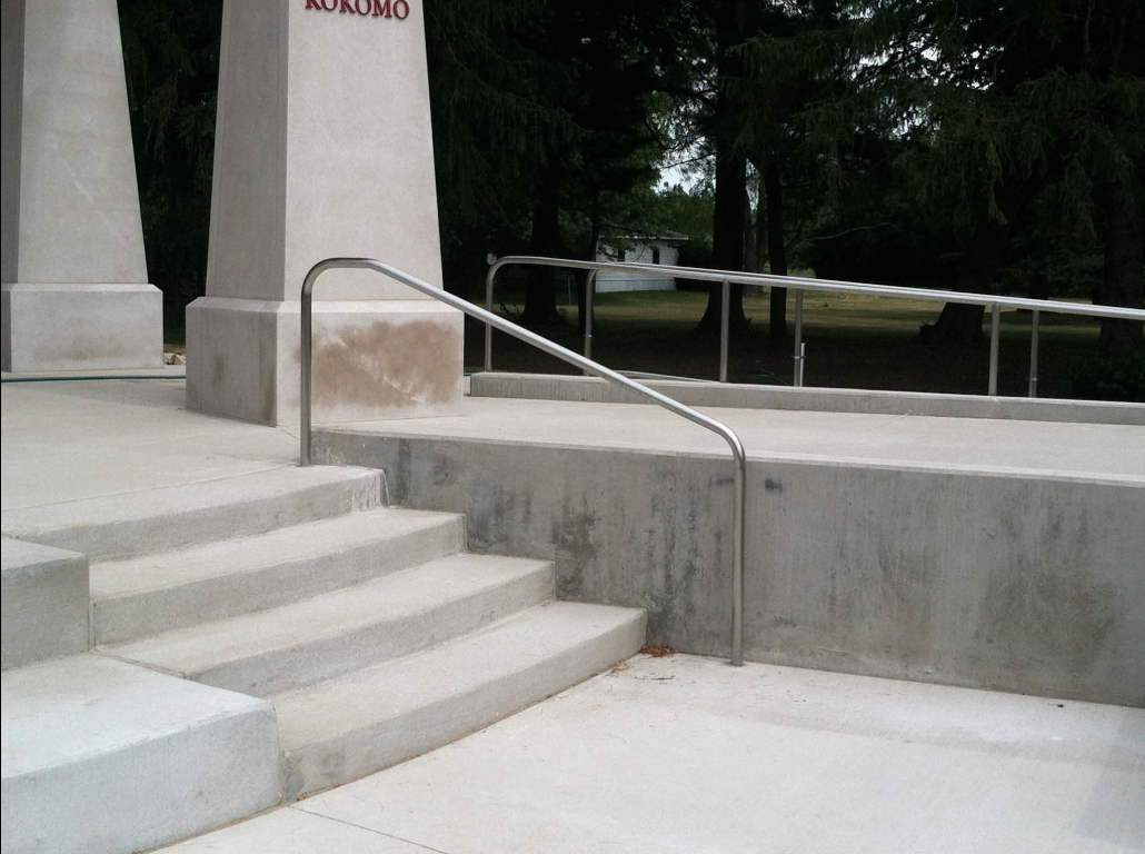 Custom railing systems coordinated with site concrete features to meet accessibility and safety requirements across elevation changes.