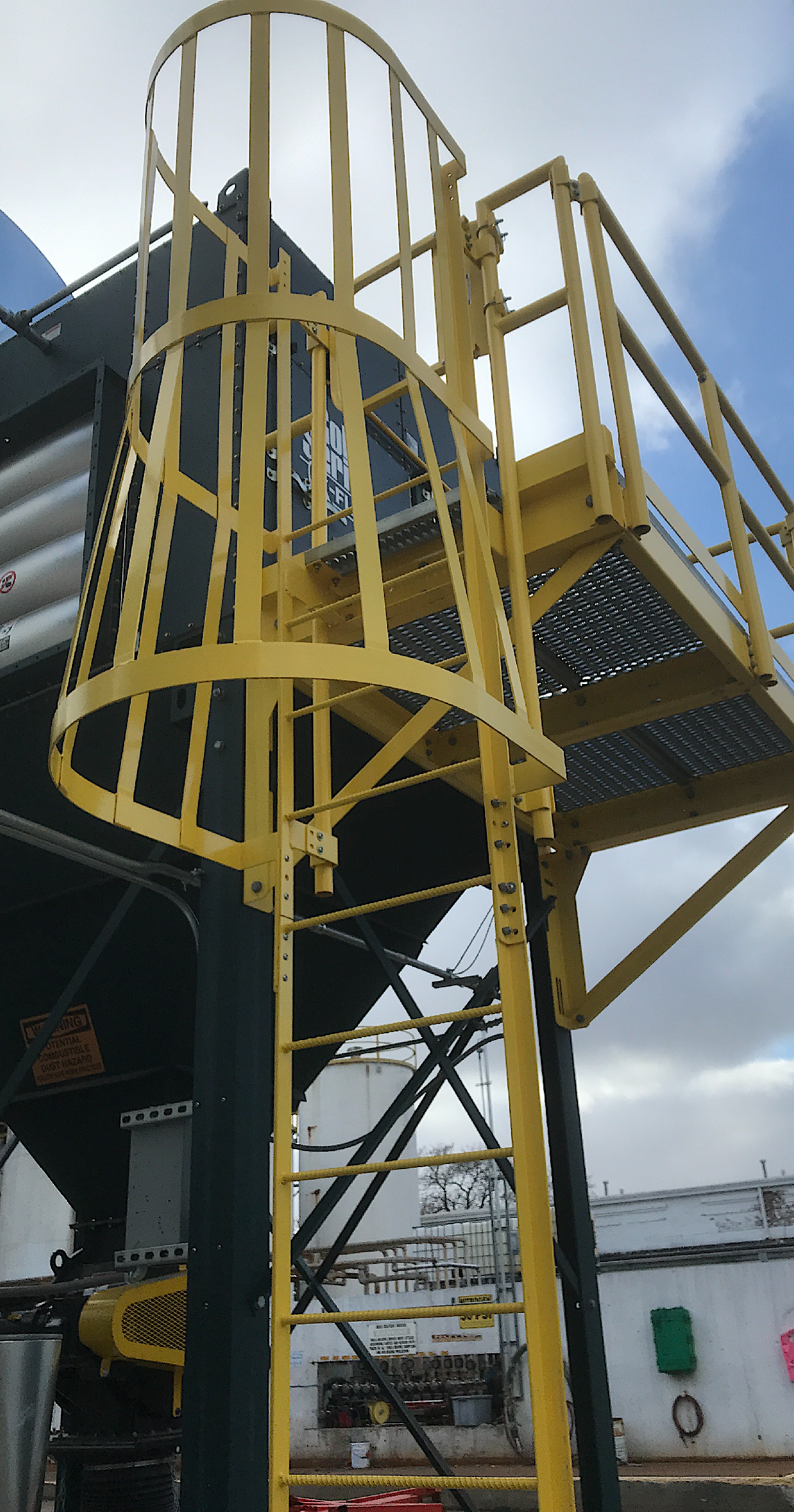 Industrial steel stairs and safety railing system fabricated for equipment access.
