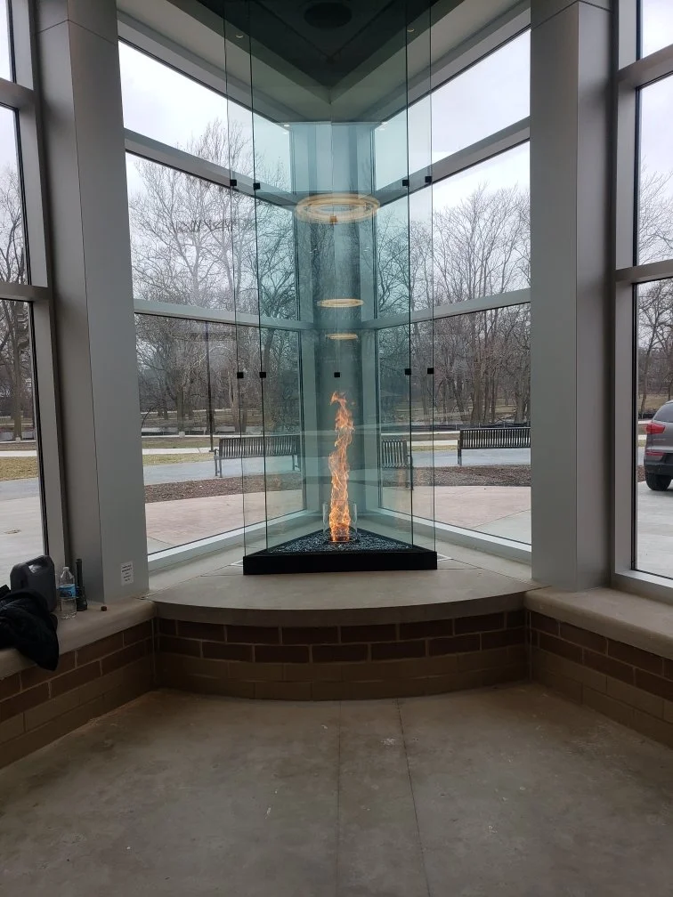 Custom Glass Enclosed Fireplace Feature in Lobby.