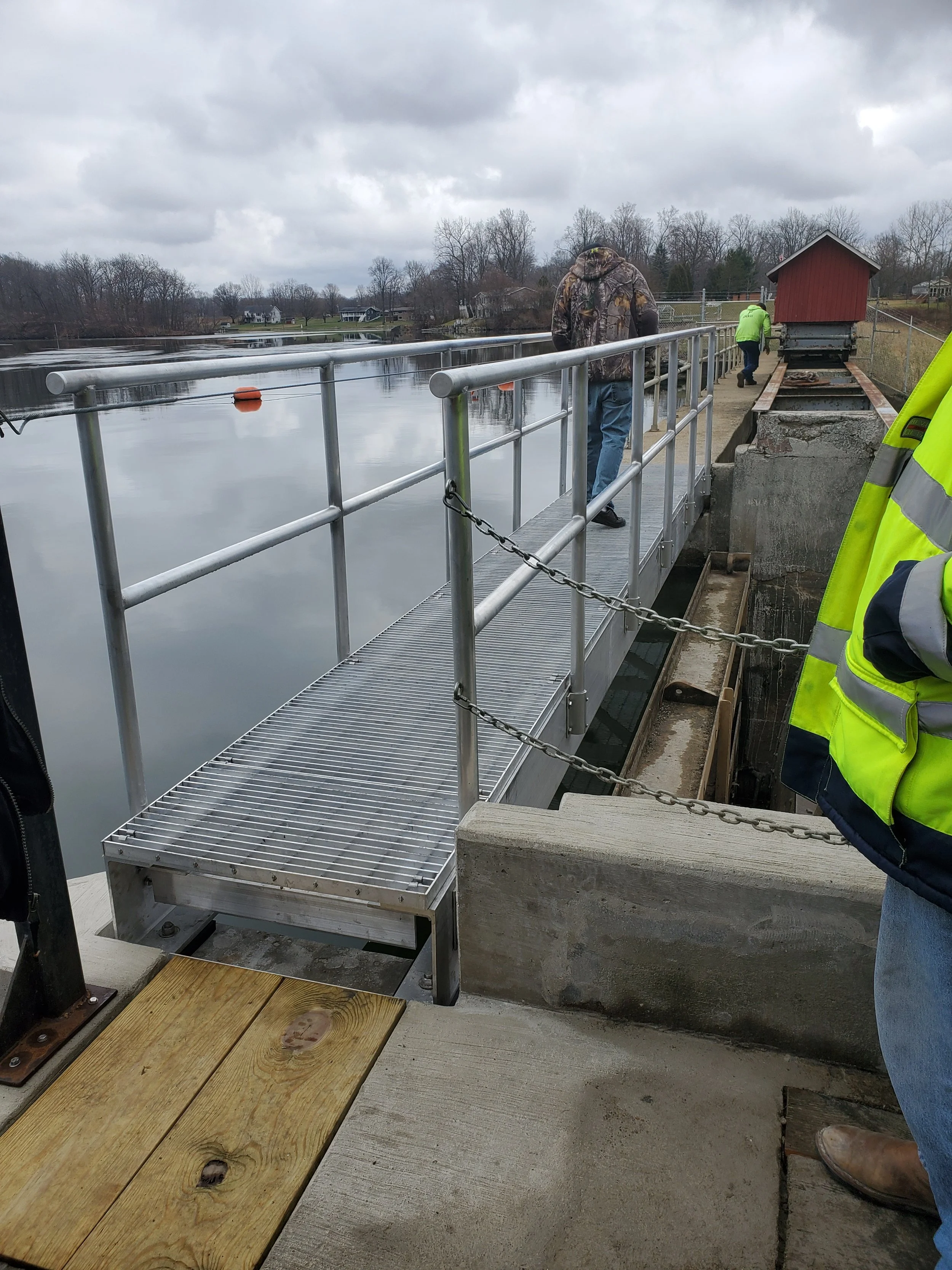 Steel pedestrian walkway with guardrails fabricated for waterway infrastructure.