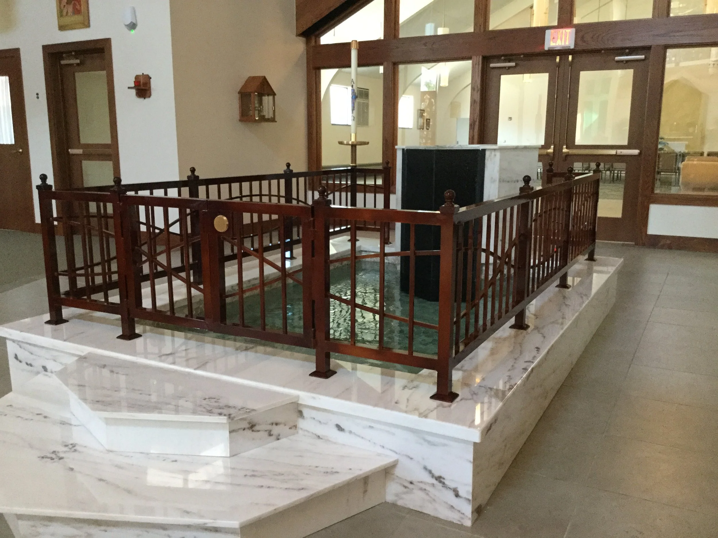 Decorative Baptismal Font Enclosure Featuring Custom Fabricated Gate and Architectural Detailing.