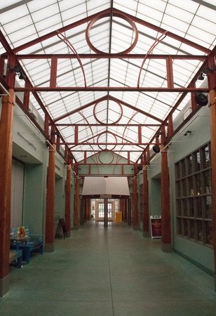 Exposed Structural Steel Framing with Custom Circular Elements Supporting the Atrium Roof System.