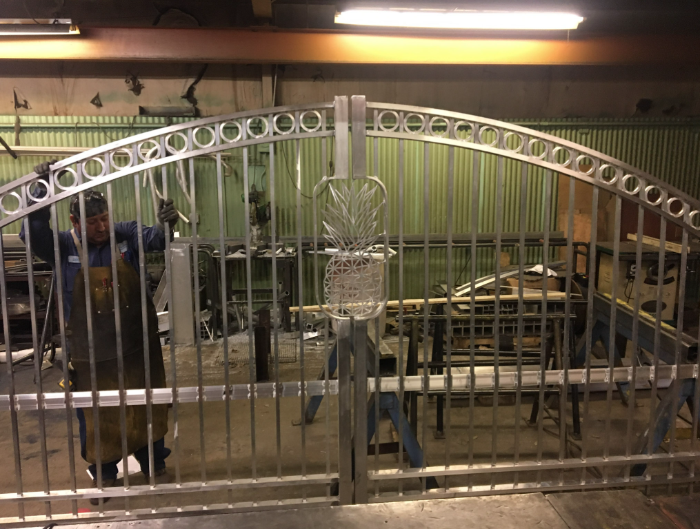 Ornamental metal gate fabrication in progress in metal fabrication shop.