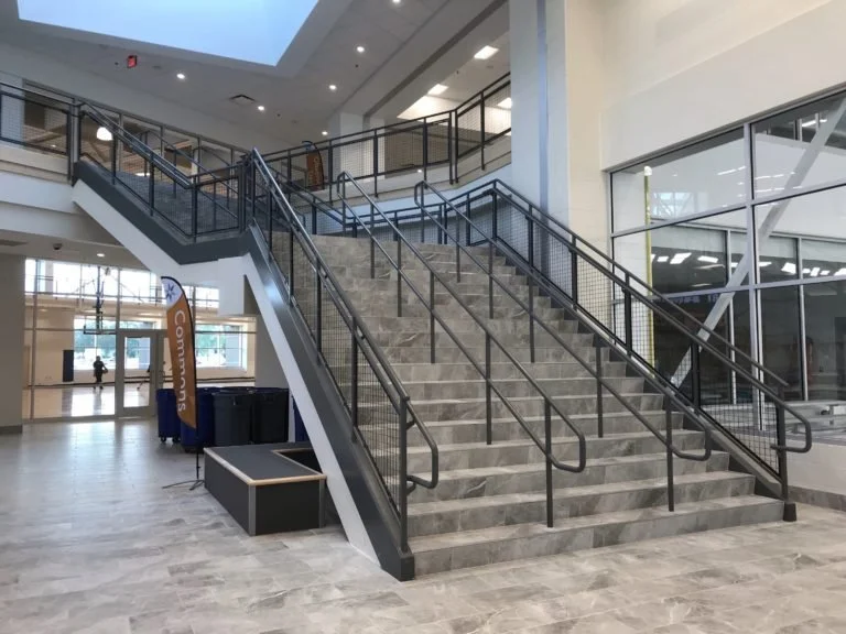 Interior Stair with Continuous Handrails Supporting Multi-Level Circulation within the Aquatics Facility.