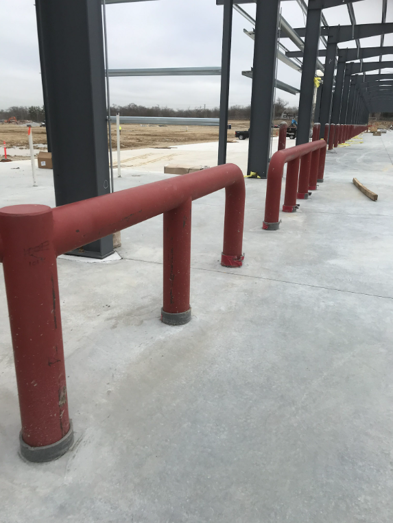 Steel structural supports and site safety barriers during construction.