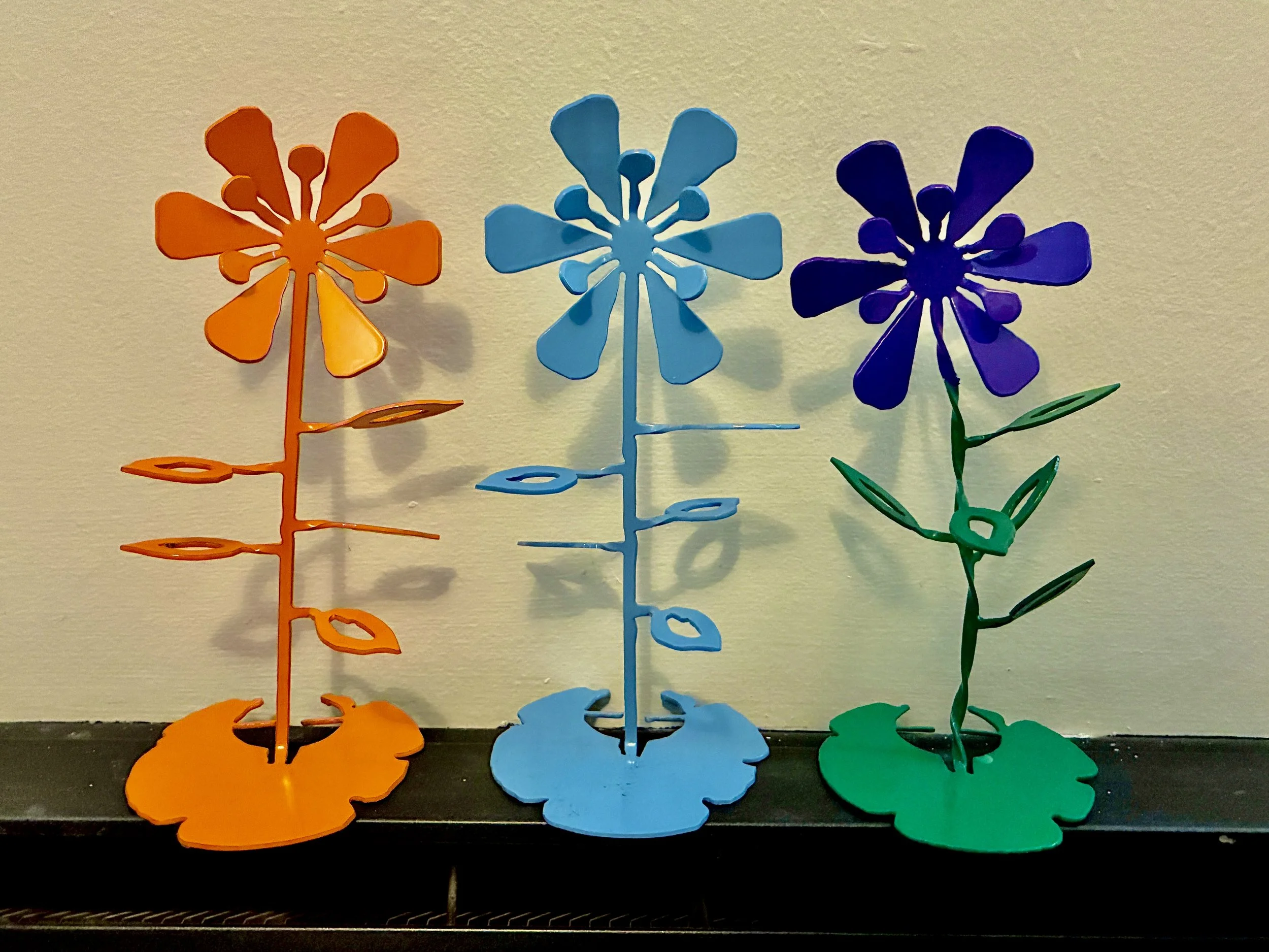 Custom fabricated metal flower sculptures.