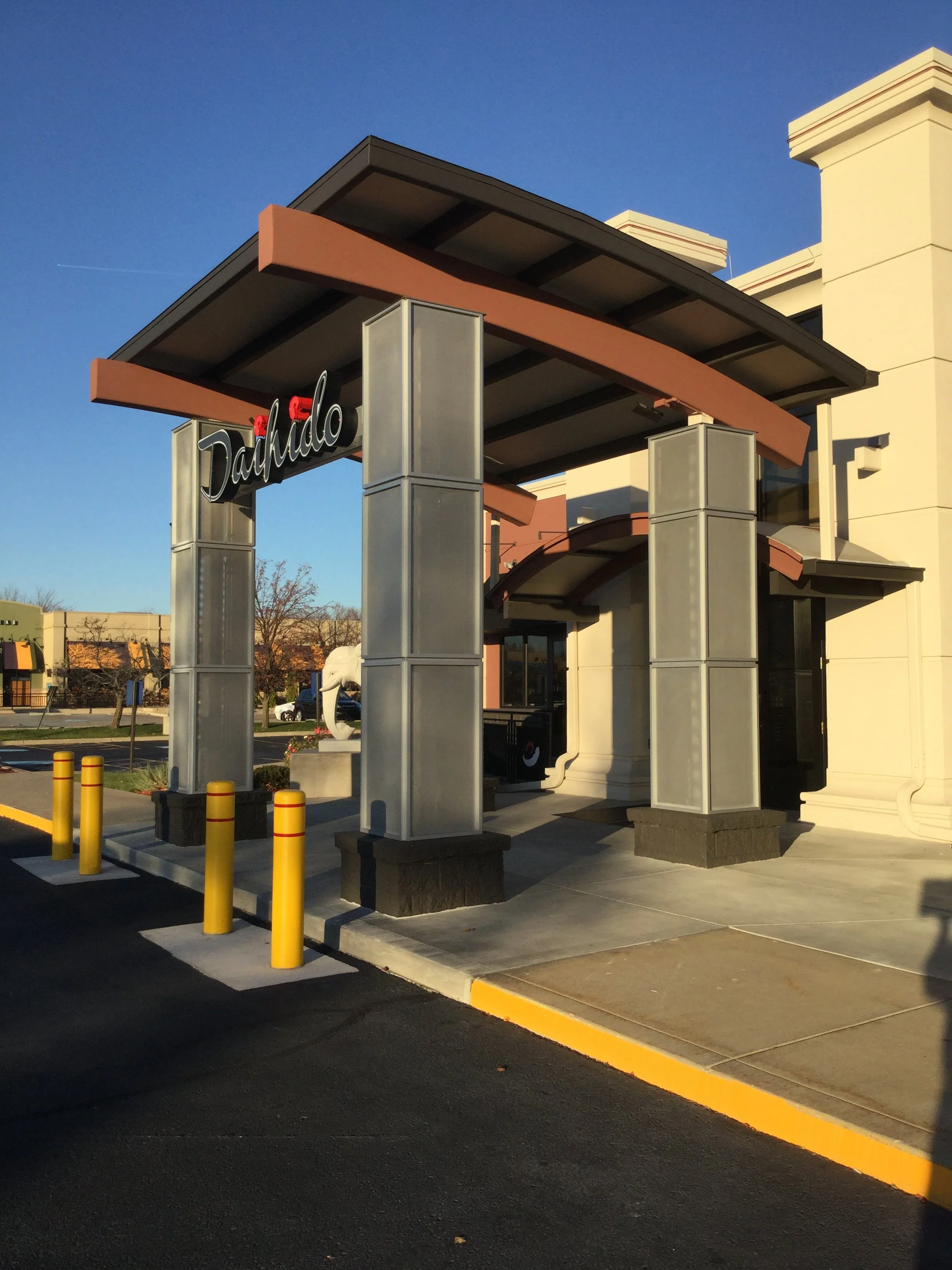 Steel Canopy Structure with Integrated Signage Support at the Entrance.