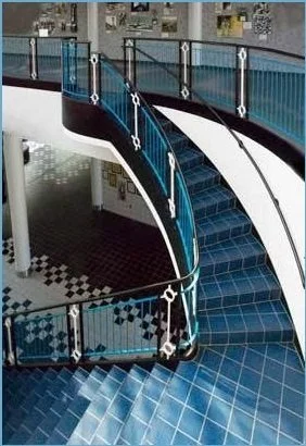 Architectural Steel Stair System with Custom Curved Stringers and Guardrails.