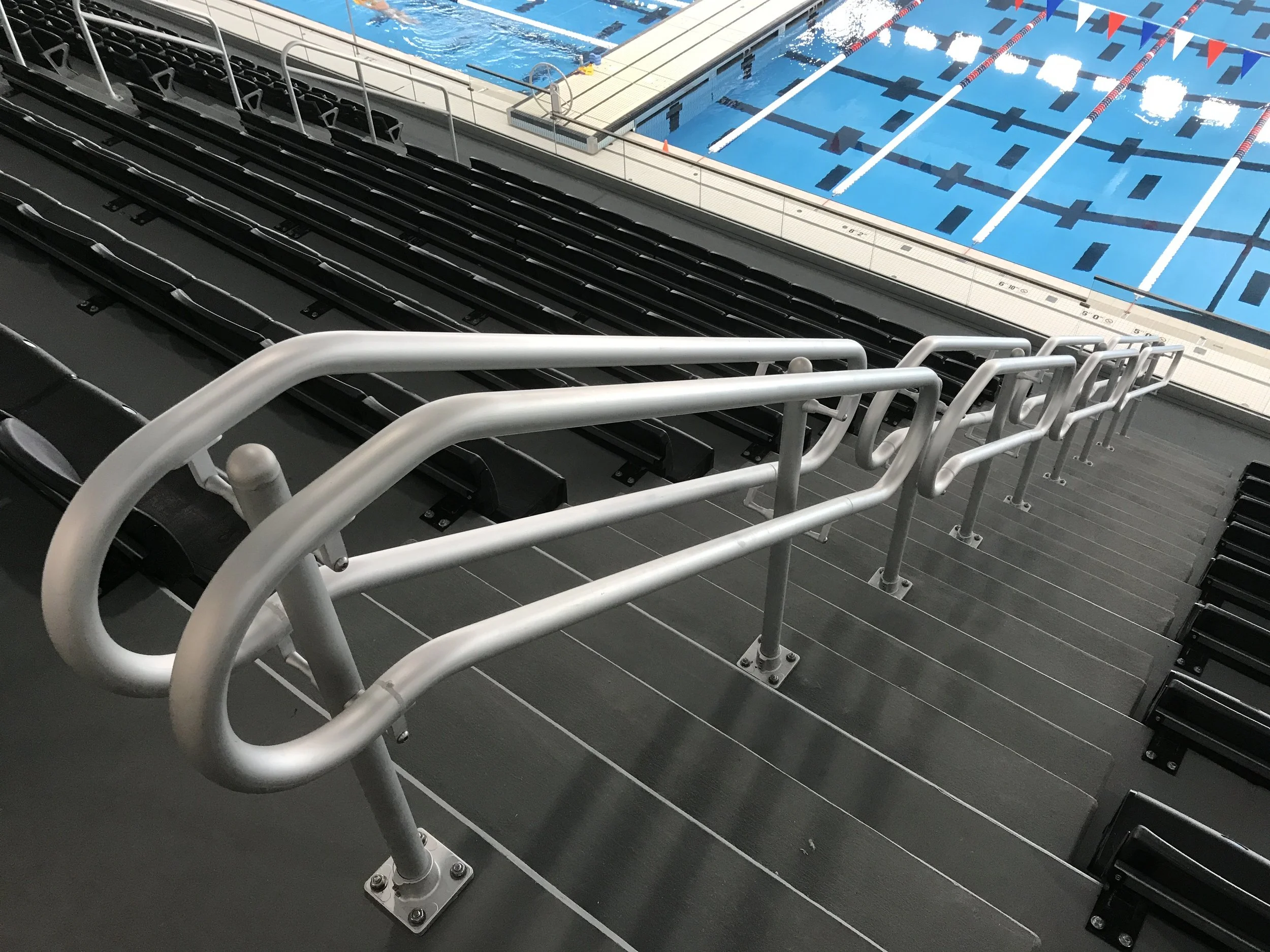 Stainless Steel Aisle Handrails Fabricated for Spectator Seating at the Aquatics Center.