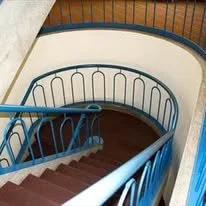 Curved Interior Stair with Custom Ornamental railing at Saint Mary's College.