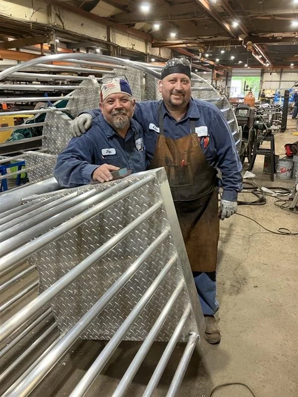 Workers inside metal fabrication shop