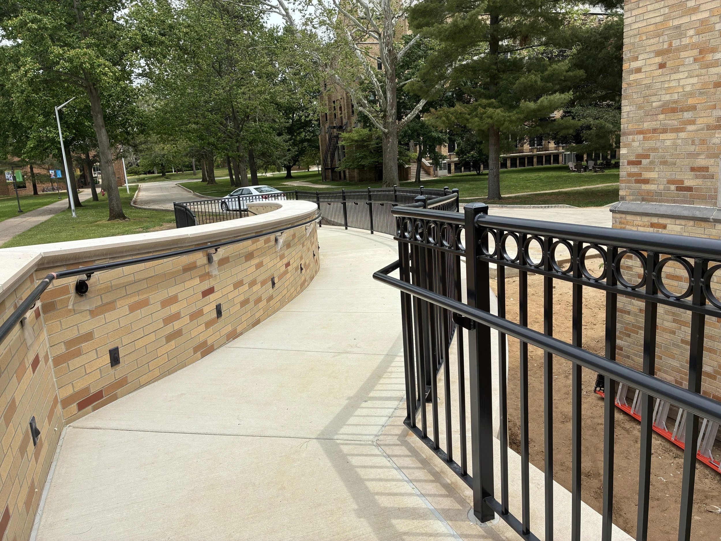 Custom Steel Railing System Integrated Along Curved Access Path at LeMans Hall.