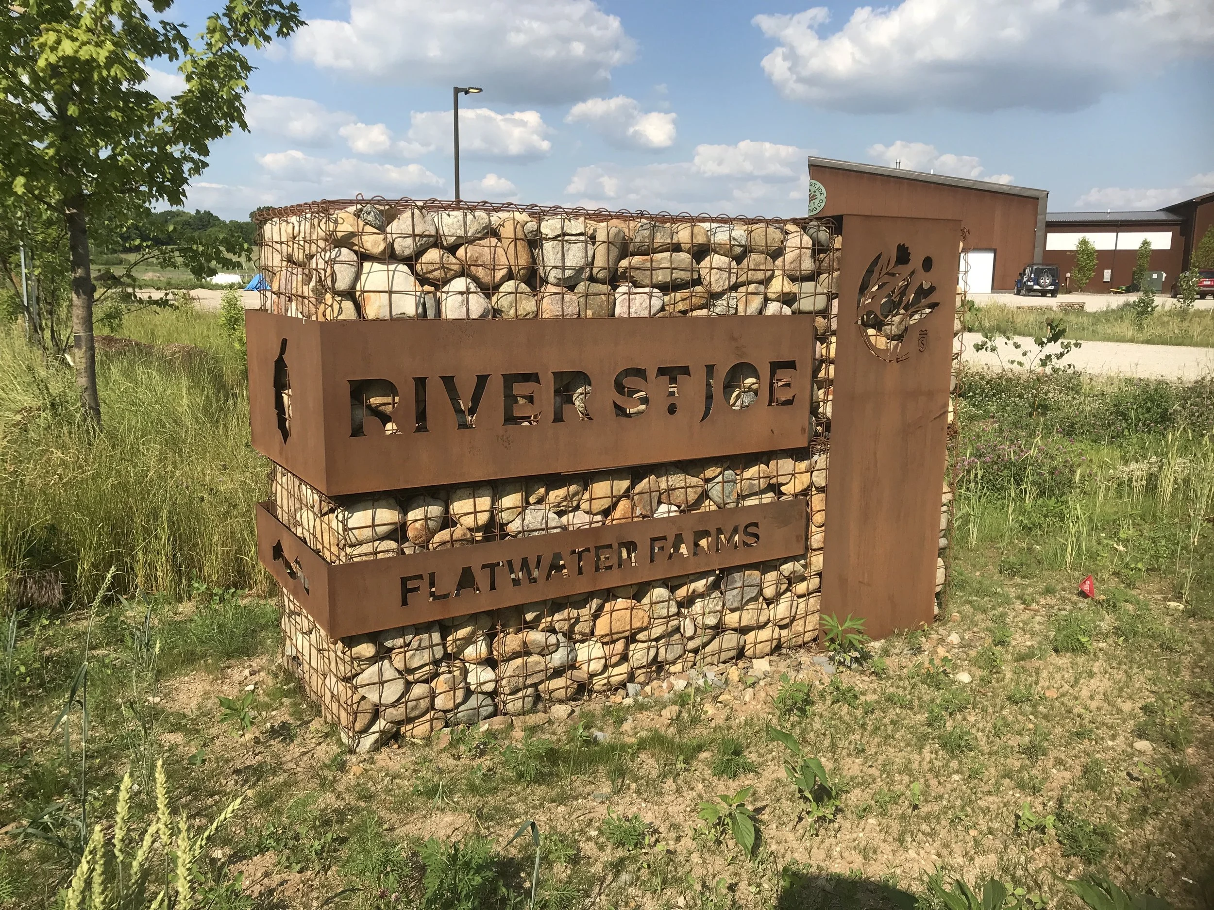 Custom weathering steel site sign fabricated for Flatwater Farms.