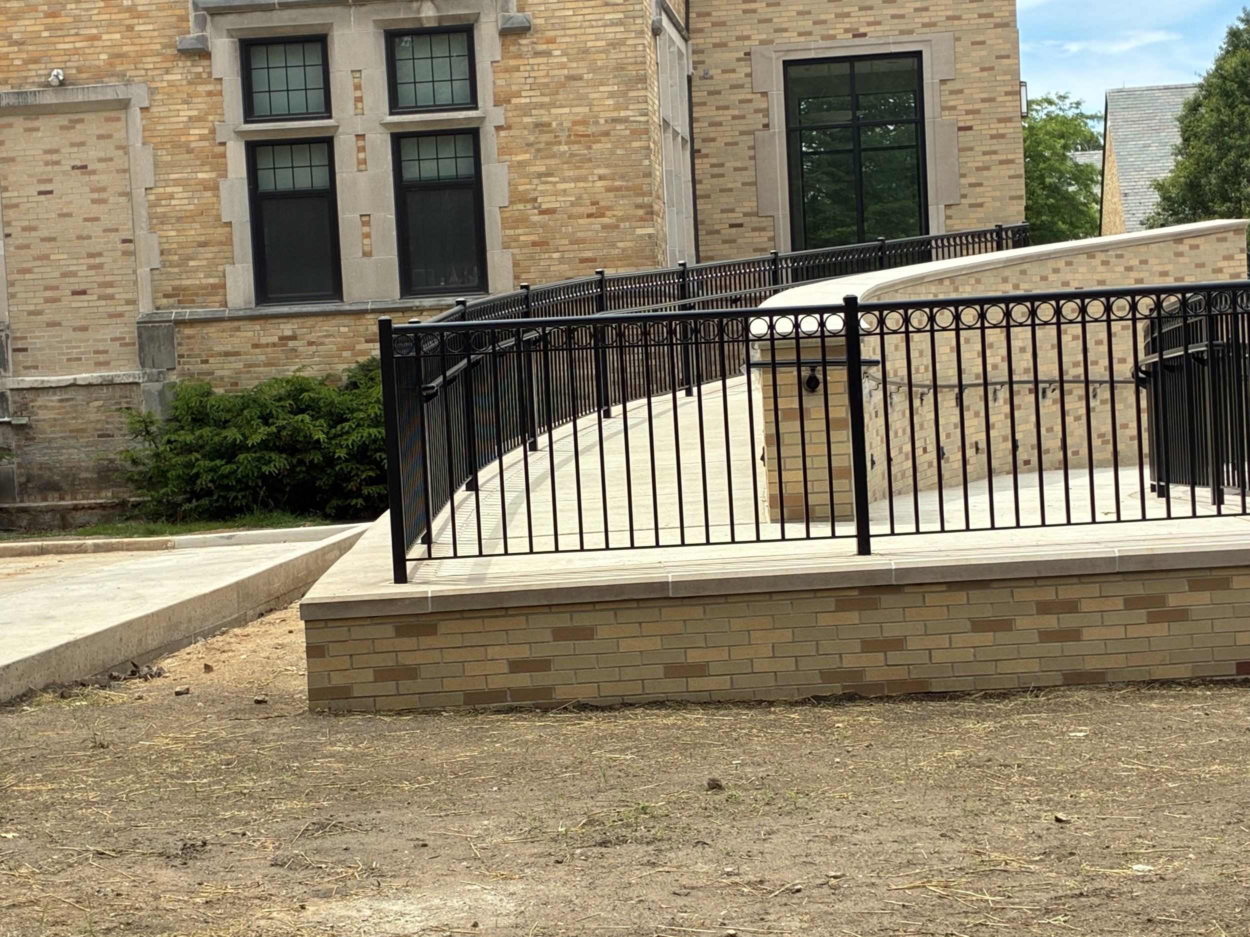 Custom Steel Railing System Integrated Along Curved Ramp Access at LeMans Hall.