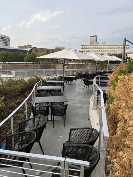 Custom Curved Metal Railings Guiding Pedestrian Flow along the Patio Perimeter.
