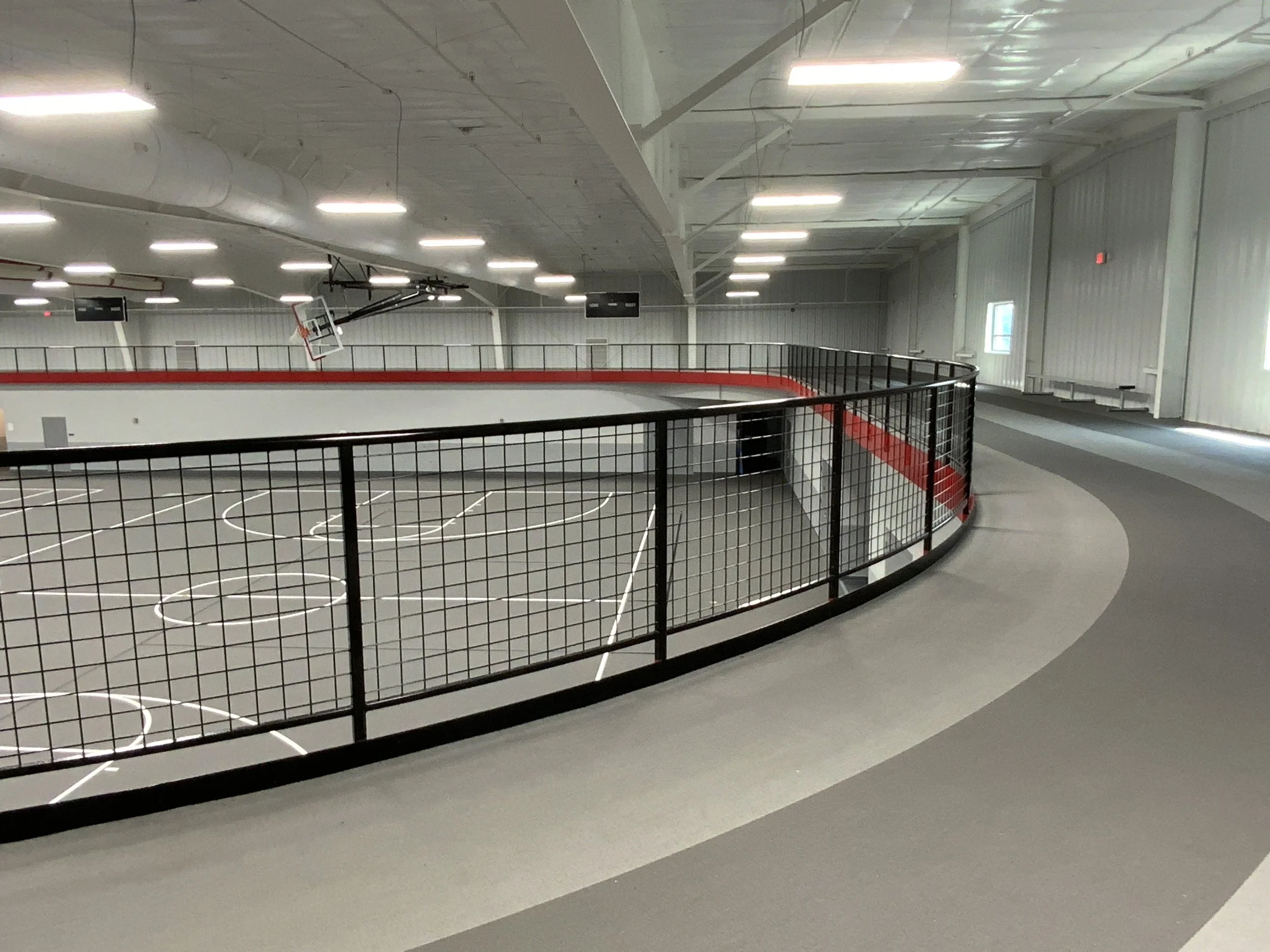 Powder-Coated Steel Railings Fabricated to Follow the Unique Geometry of the Indoor Track.