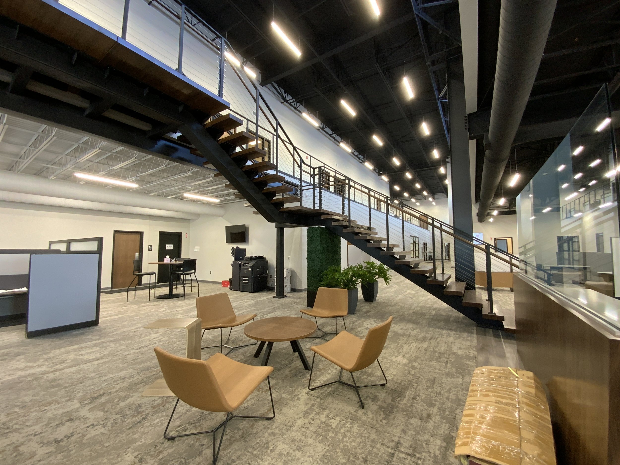 Interior stair with custom metal railing in office setting.