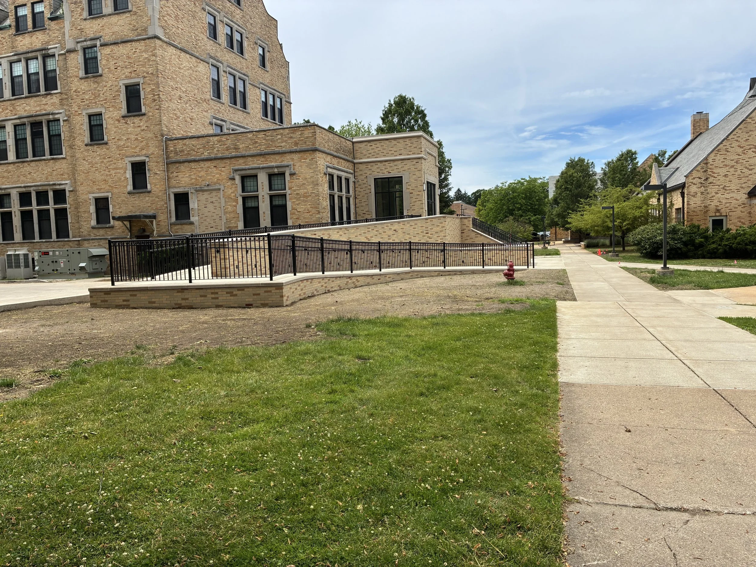 Full Exterior View of Installed Railing System at LeMans Hall, Maintaining Uniform Design Across Walkways and Access Points.