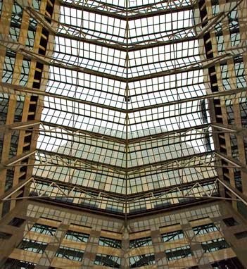 Upward Interior View Emphasizing Vertical Scale and Repeating Steel Framing Elements.