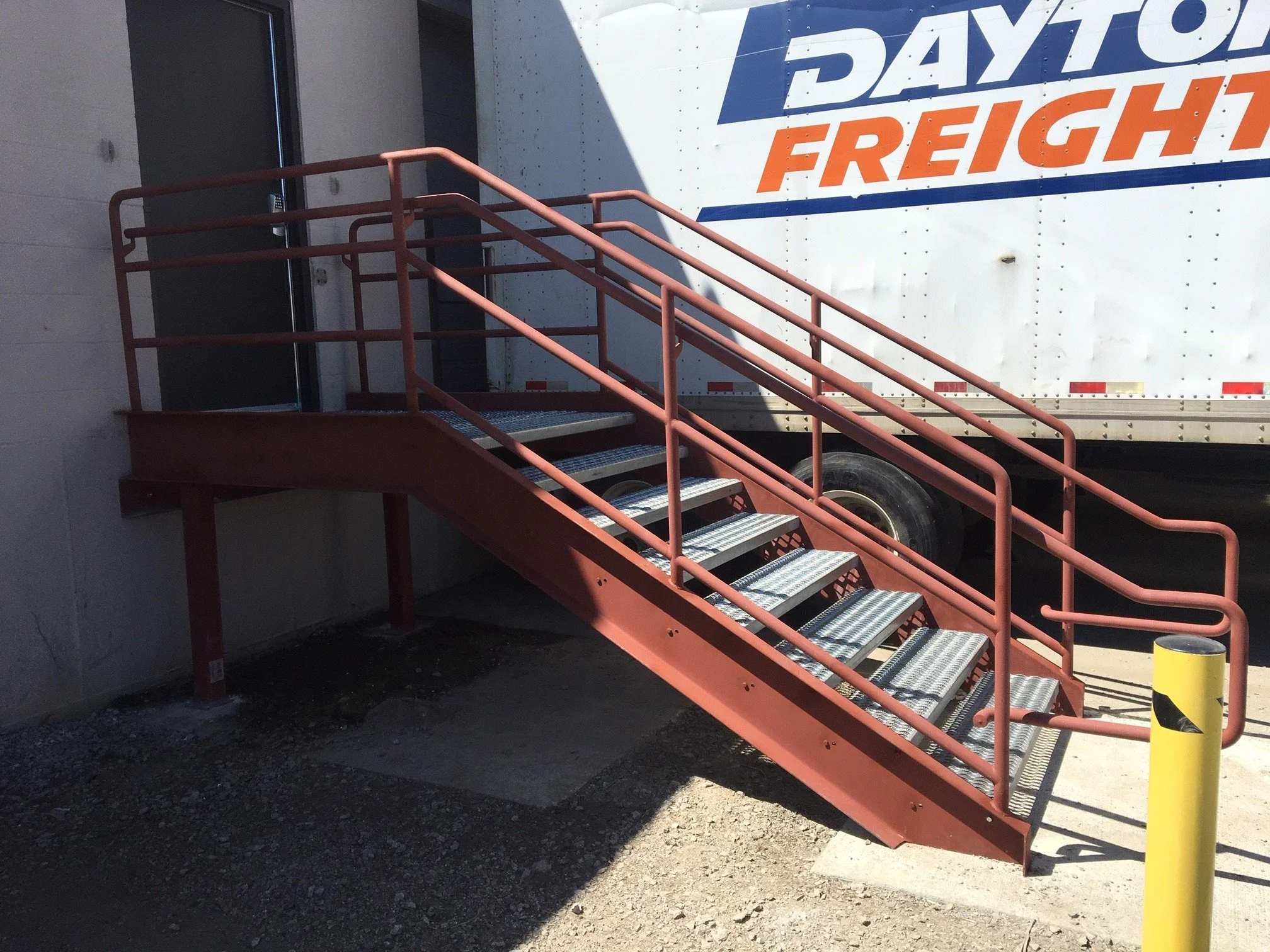 Industrial Stairway Featuring Safety Railings, Grating Treads, and Elevated Access Platform.