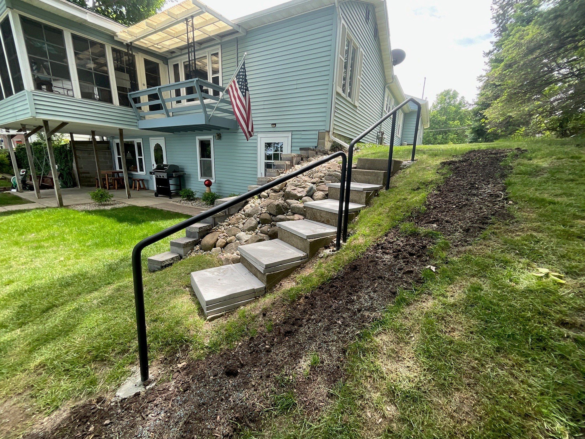 Durable Steel Handrail Providing Secure Access Along a Sloped Residential Walkway.