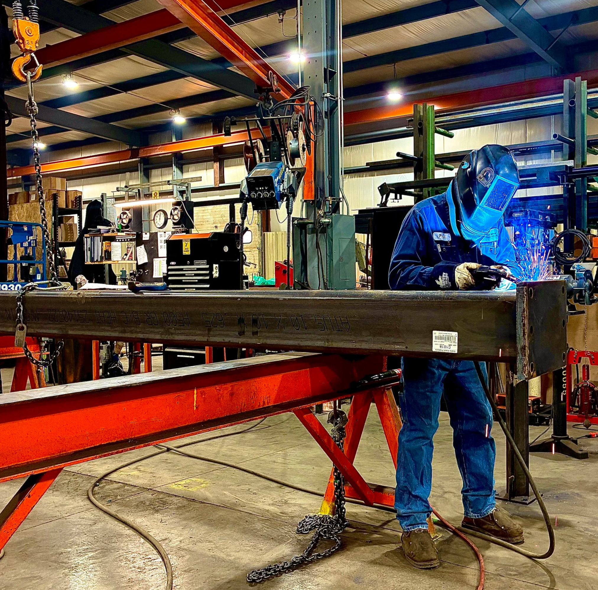 Welder fabricating steel components