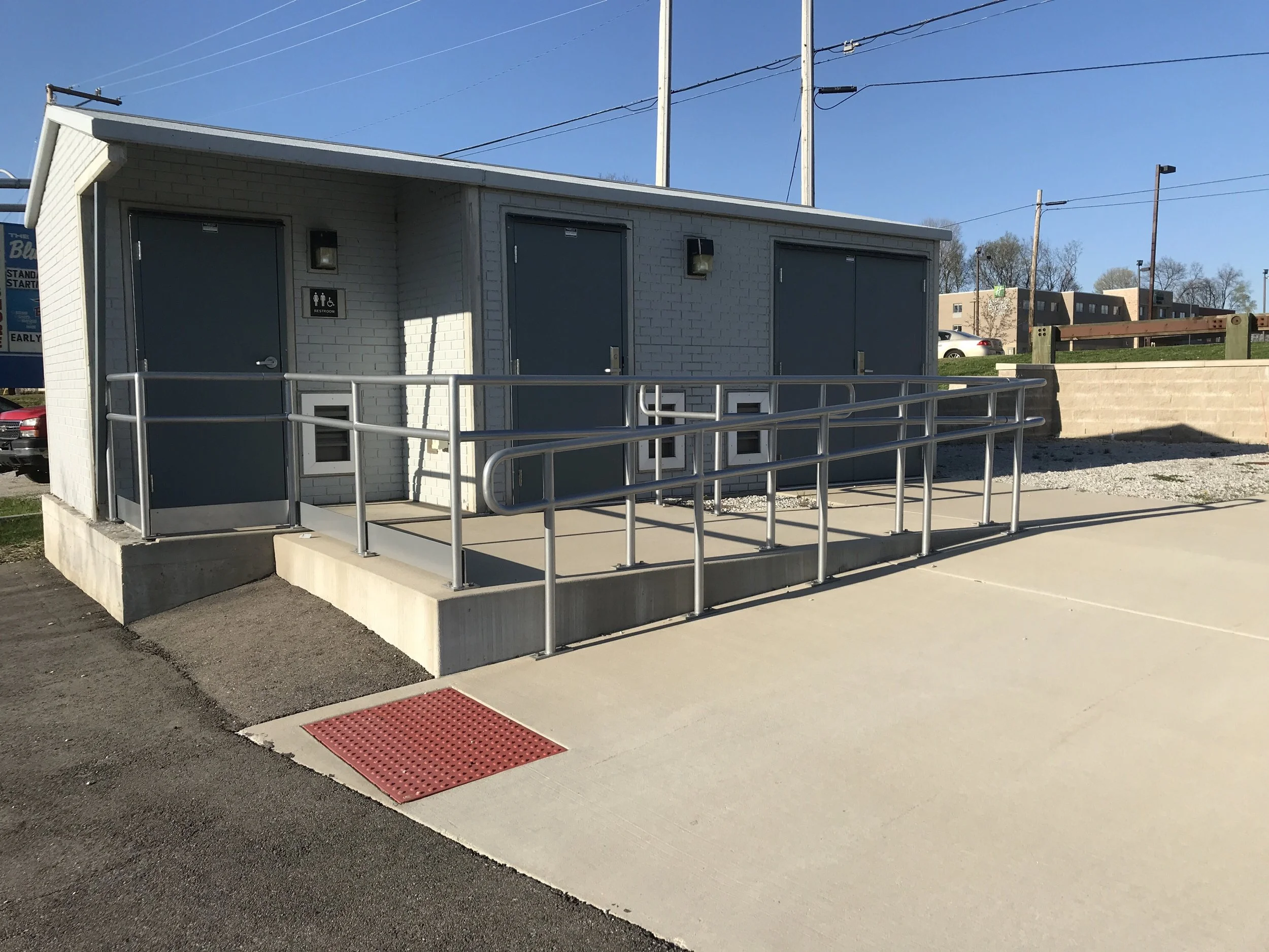 Exterior accessibility ramp with custom metal railings fabricated for a public facility.