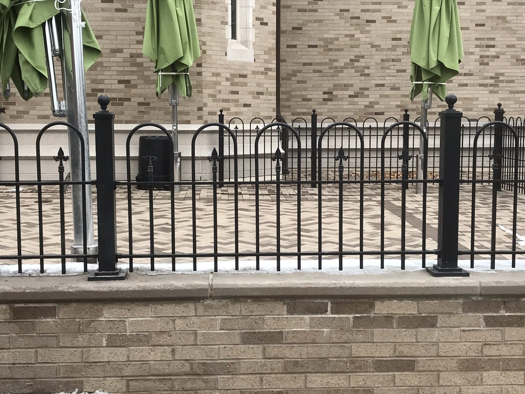 Decorative Powder-Coated Steel Fencing Surrounding the Eck Visitors Center Patio and Courtyard Spaces.