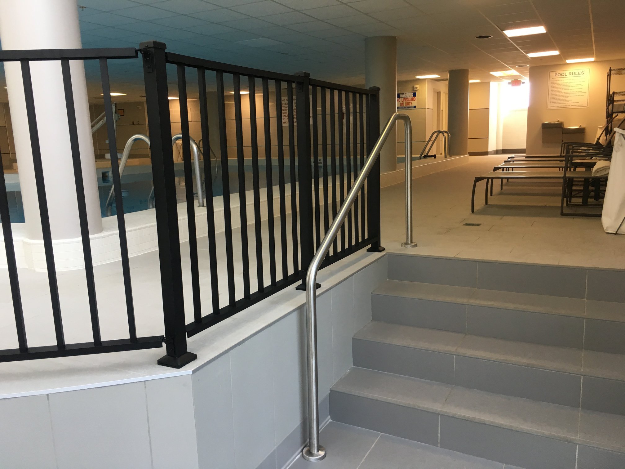 Interior Stair and Handrail Transition Integrated with Adjacent Guardrail Systems.