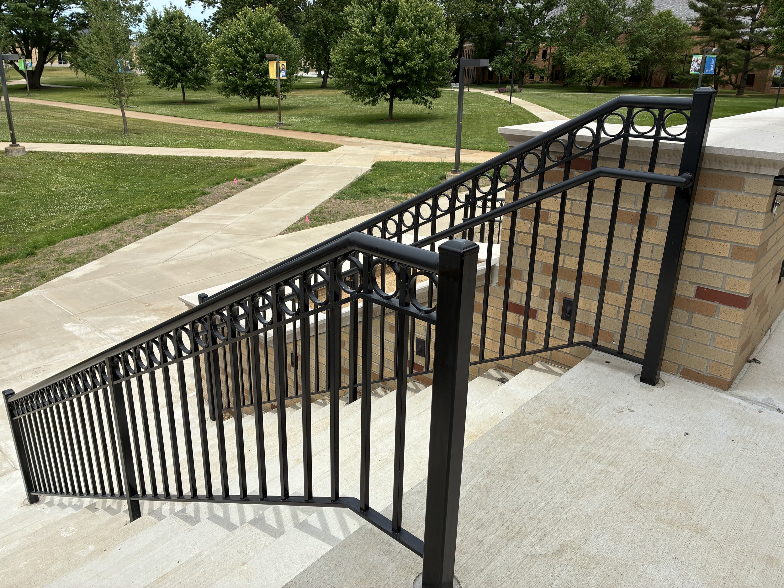 Custom Steel Railing System Installed Along Stairs and Adjacent Walkways at LeMans Hall.