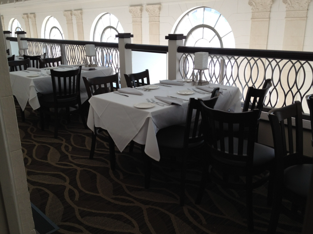 Custom ornamental steel railing along the upper‑level dining area.