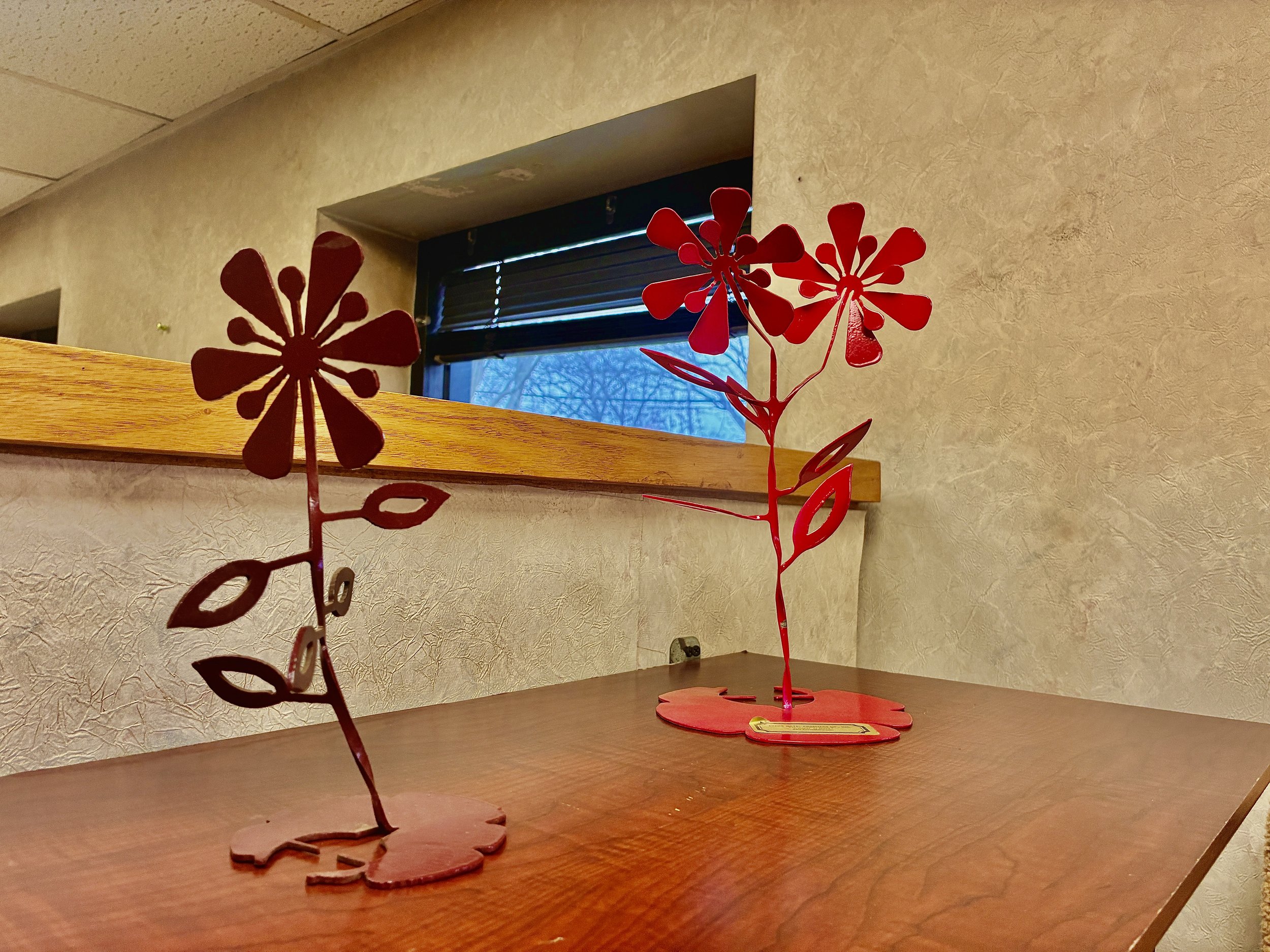 Custom fabricated metal flower sculptures.