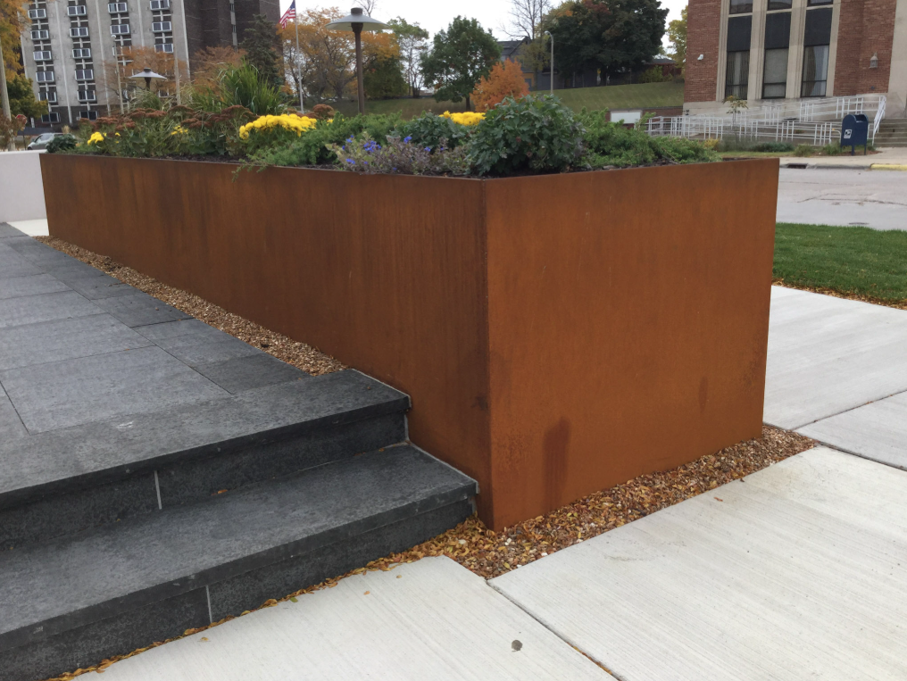 Weathering Steel Planter Walls Fabricated for the Memorial Plaza, Integrating Site Circulation and Landscape Elements.