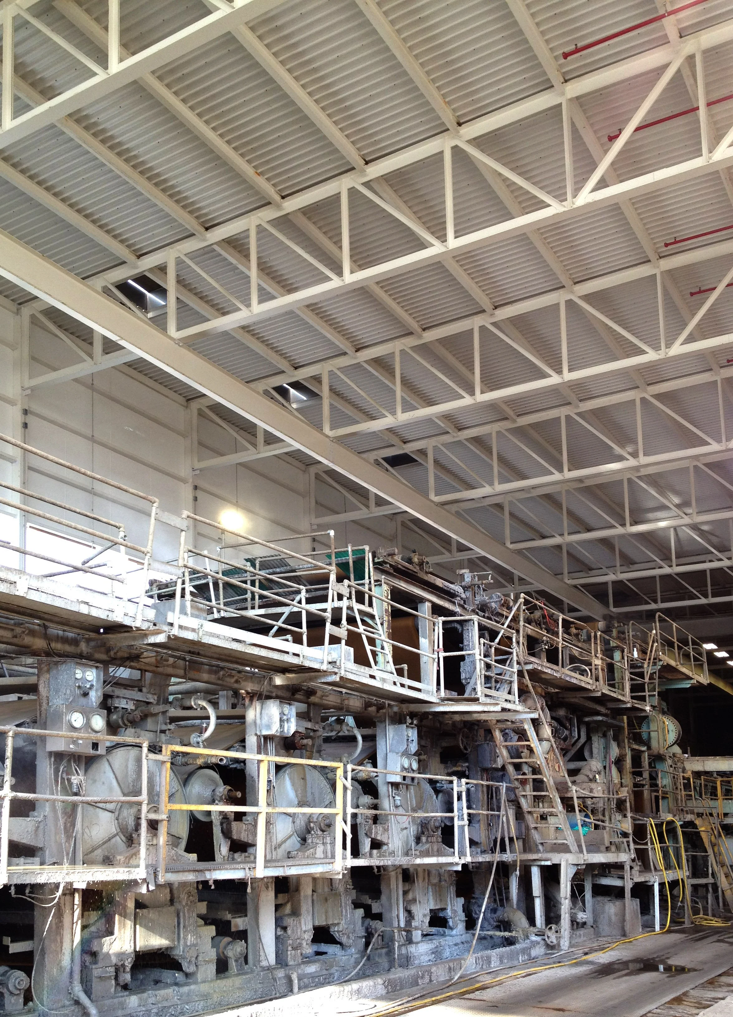 Industrial facility interior with steel walkways and structural framing.