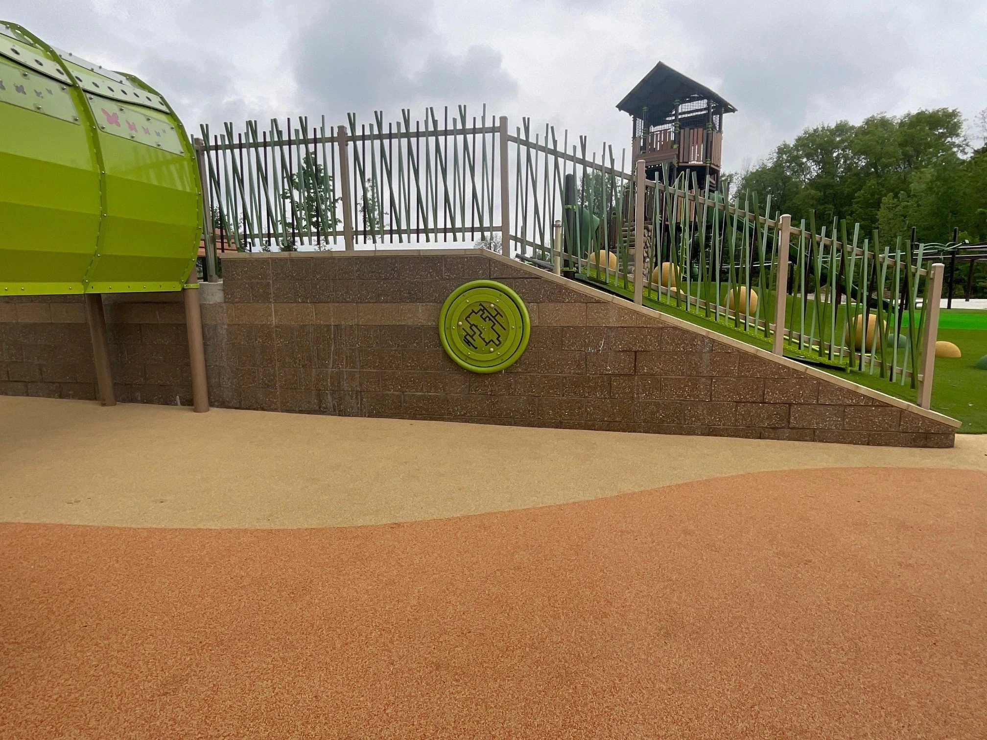 Custom fabricated metal railing featuring a decorative branch-style pattern for playgrounds, parks, and public gathering spaces.