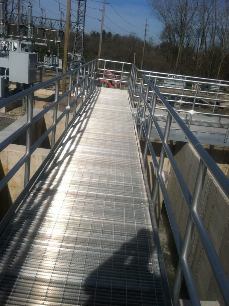 Industrial steel safety walkway with guardrails fabricated for elevated access.