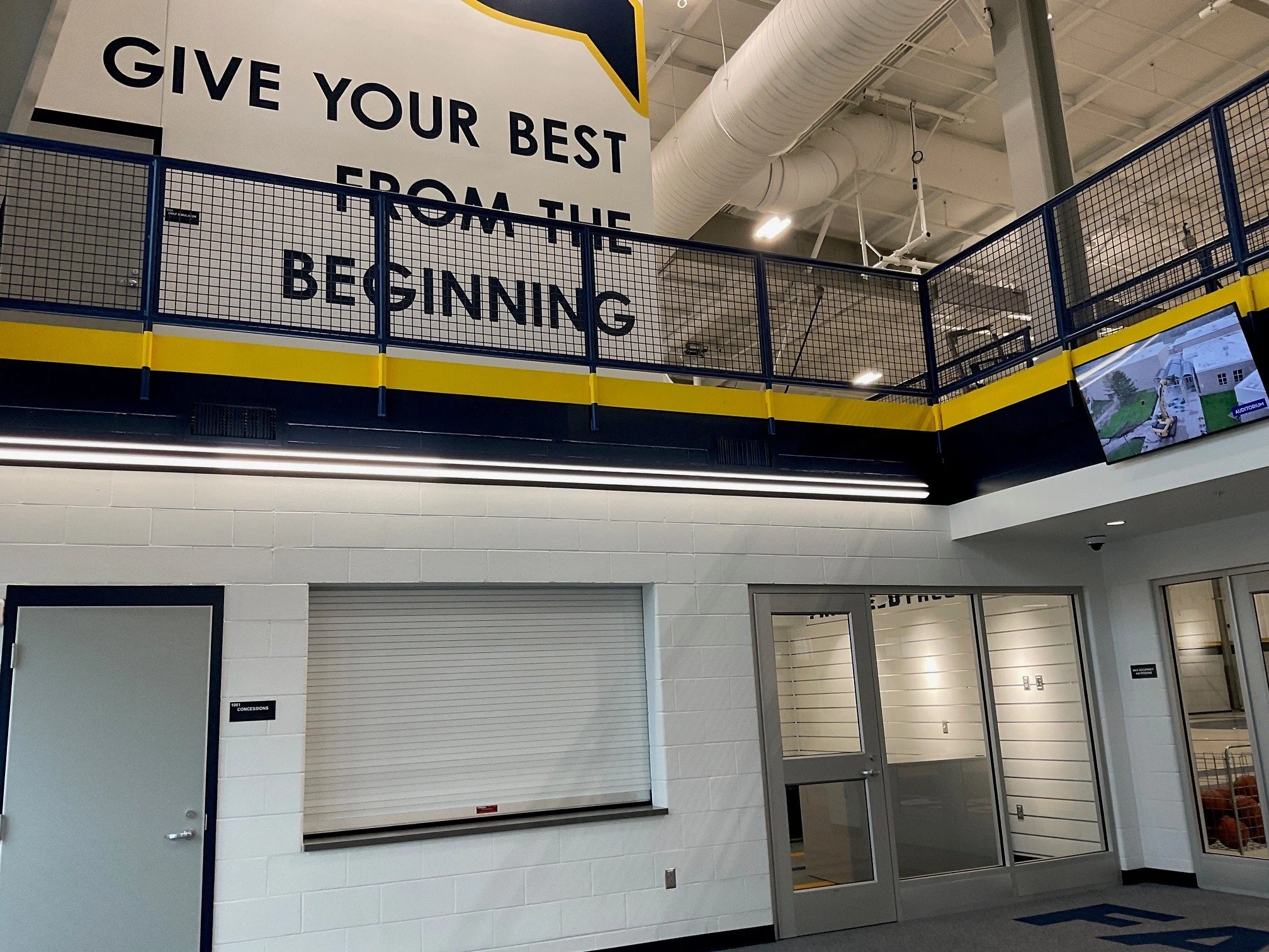Powder-Coated Steel Mesh Railing System Surrounding Indoor Athletic Observation and Training Areas.