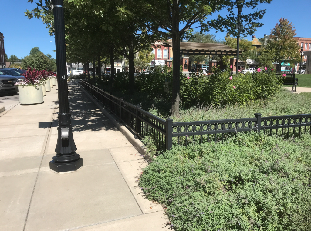 Continuous pedestrian railings installed along the plaza perimeter to provide safety and visual consistency throughout the public space.