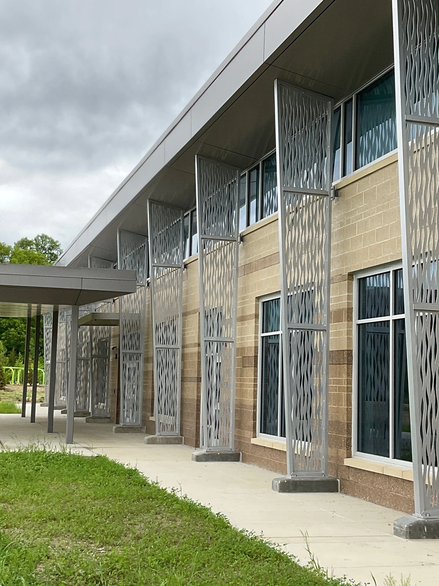 Decorative architectural metal panels installed on the exterior of a commercial building.