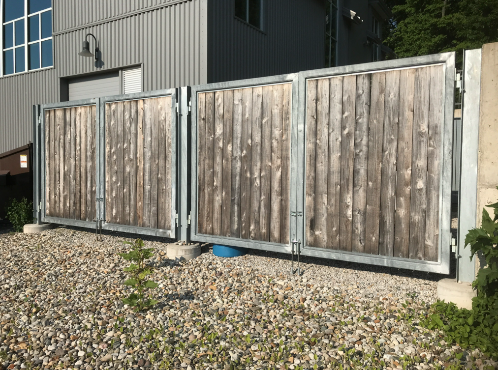 Custom fabricated metal gate with wood infill panels.