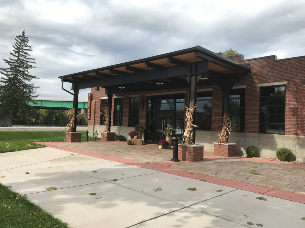 Custom steel canopy framing coordinated with the existing brick façade to integrate seamlessly into the building’s exterior design.