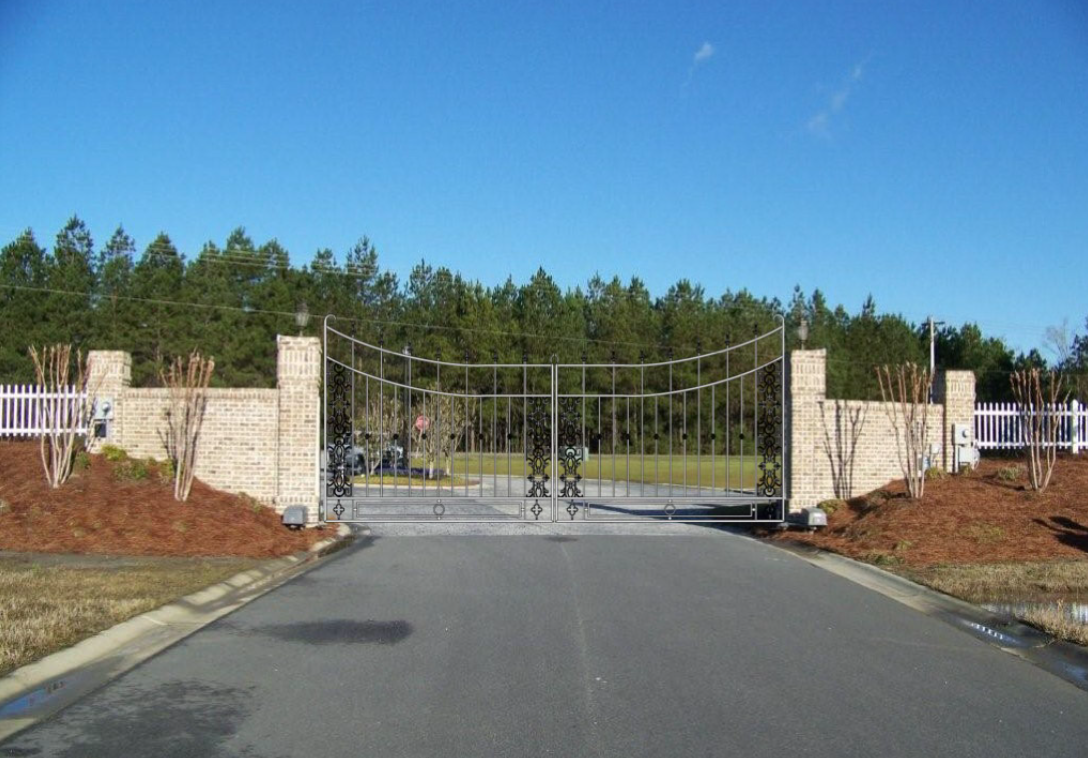 Decorative metal entry gates fabricated for landscaped site entrance.