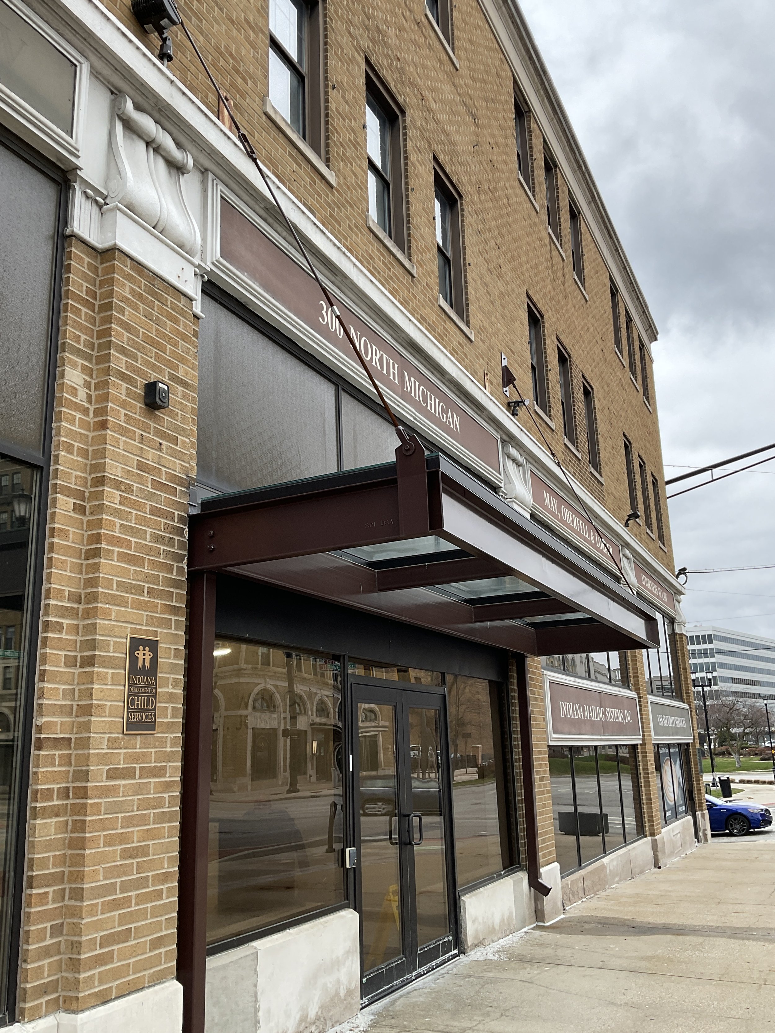 Commercial building exterior with metal entry elements.