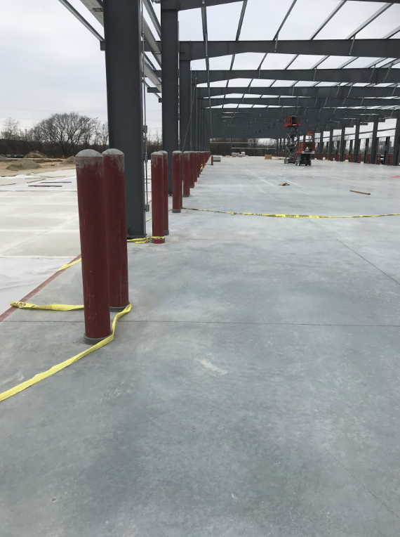 Structural steel framing and site safety elements under construction at commercial project.