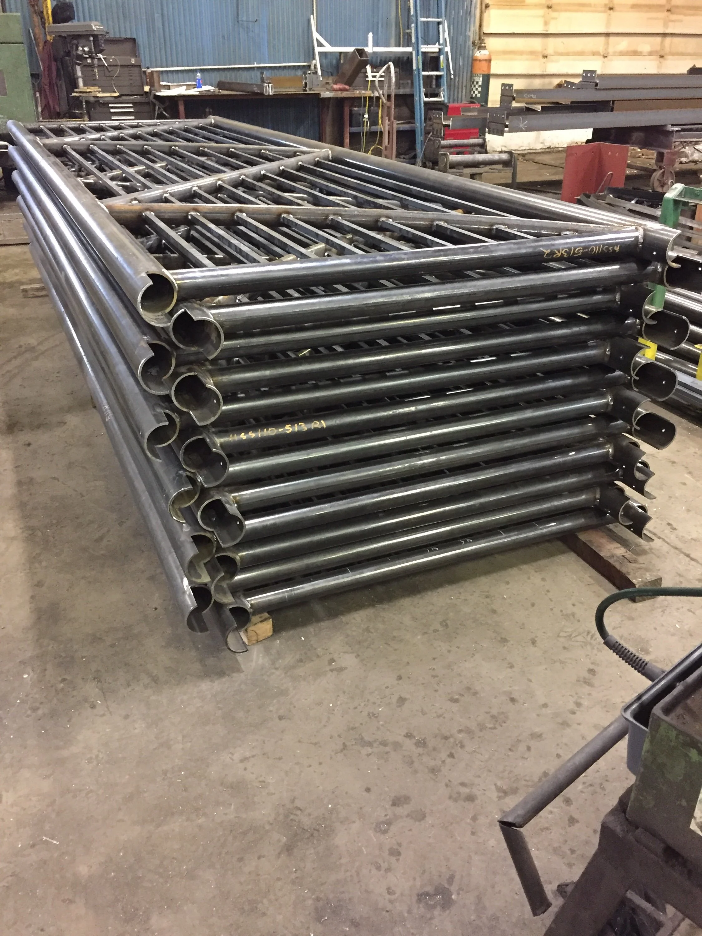 Steel pipe components staged in metal fabrication shop.