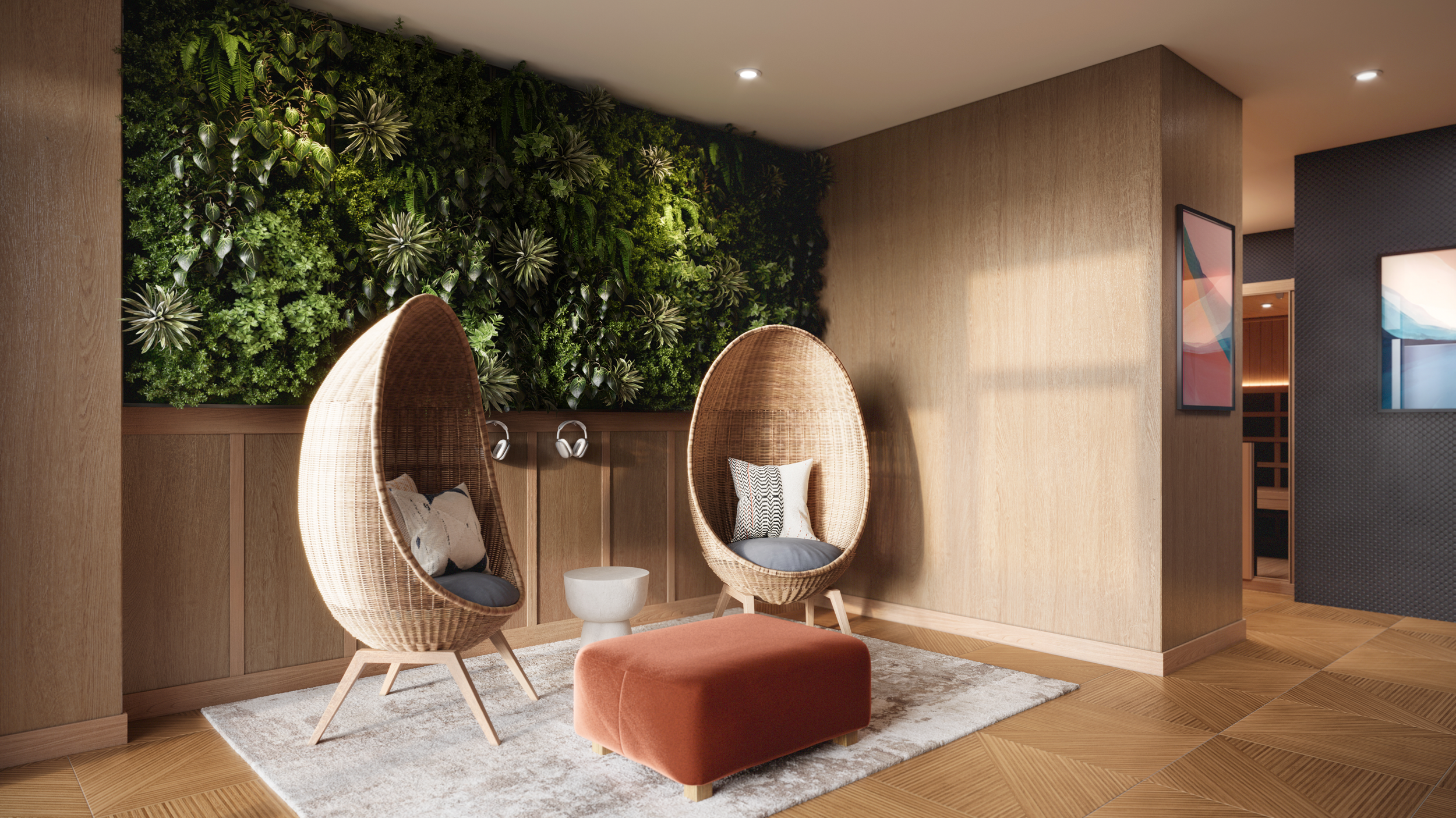 Modern interior with two hanging egg-shaped wicker chairs with cushions, a small round white side table, a burnt orange ottoman, a textured beige area rug, wooden walls and flooring, a green living wall with various plants, and abstract art on the walls.