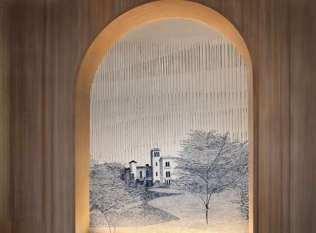 Wall art featuring a landscape with trees and a castle, framed by an arched wooden frame.