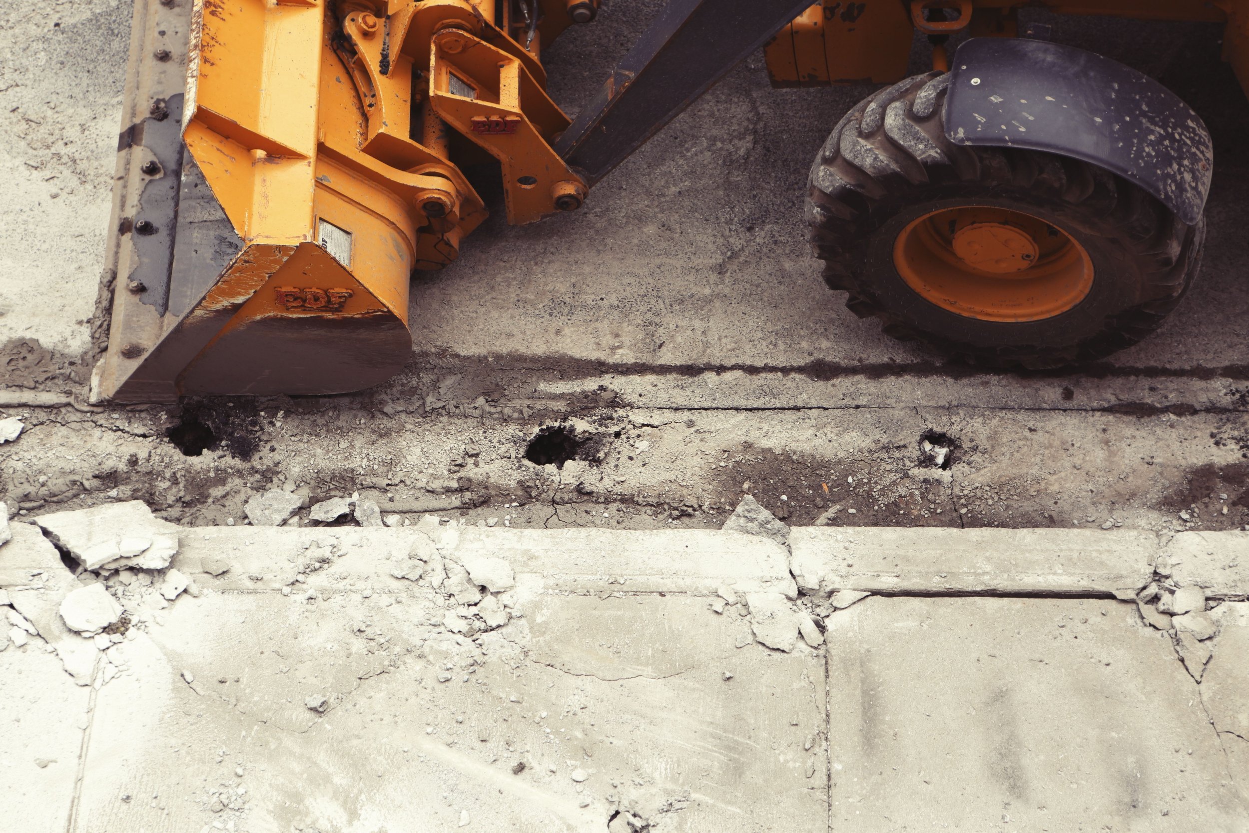 Construction equipment on a concrete surface during renovation or repair work.