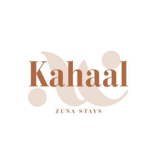 Logo with stylized text 'Katal' and 'Zuna Stays' underneath, featuring abstract shapes resembling a feather and circles.