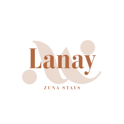Stylized logo with the words 'L Day' and 'Zuna Stays' in brown on black background.